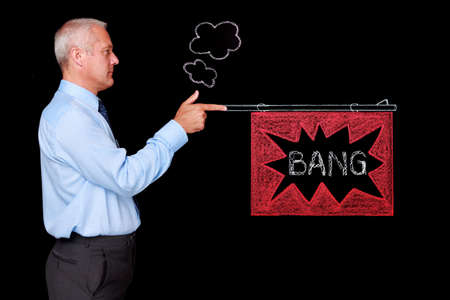 Photo of a mature businessman against a black background firing a chalk drawn gun with a BANG flag....