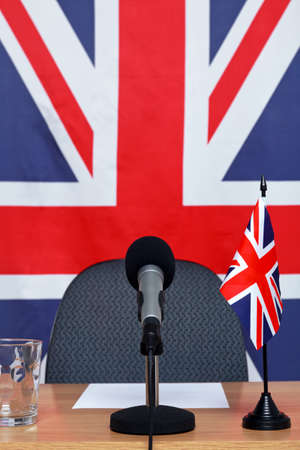 United Kingdom themed conference desk with microphone and flags.の写真素材