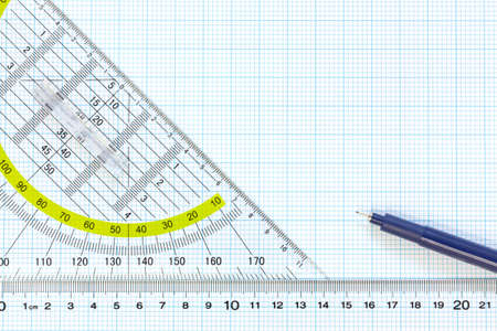 Still life photo of engineering graph paper with a fine 0 1mm pen with ruler and protractor, blank to add your own design, image or text の写真素材
