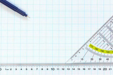 Still life photo of engineering graph paper with a fine 0 1mm pen, protractor and ruler blank to add your own design, image or text の写真素材