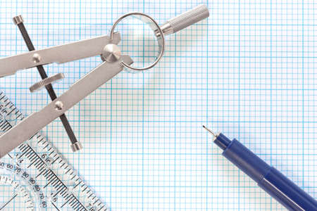 Still life photo of engineering graph paper with a fine 0 1mm pen, compass and ruler blank to add your own design, image or text の写真素材
