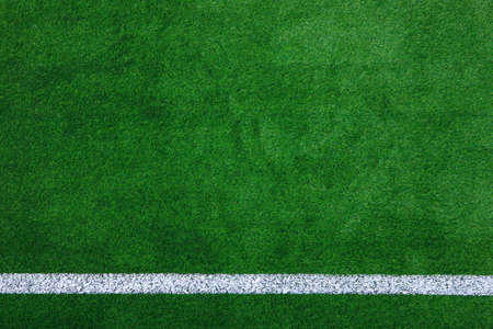 Photo of a green synthetic grass sports field with white line shot from above 