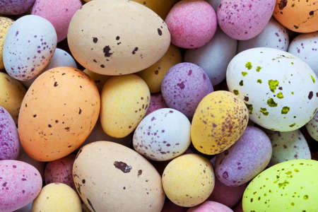 Still life photo of lots of  colourful speckled candy covered chocolate easter eggs