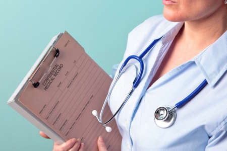 Photo of a female doctor holding a medical record