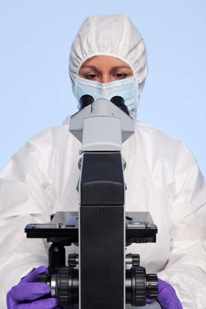 Photo of a biochemist looking at a laboratory microscope.の写真素材