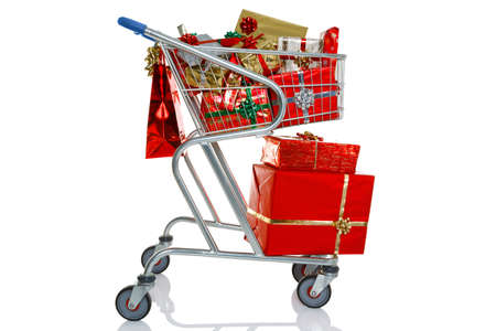 A shopping trolley full of gift wrapped Christmas presents, isolated on a white background の写真素材