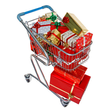 A shopping trolley full of gift wrapped Christmas presents, isolated on a white background の写真素材