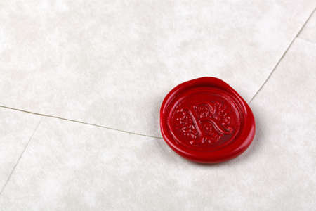 Envelope made from parchment paper sealed with a red wax sealの写真素材