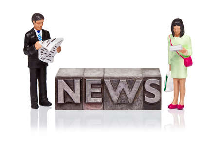 Hand painted business figurines and the word NEWS in old metal letterpress isolated on a white background.の写真素材
