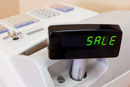 The word SALE on the display of a cash registerの写真素材
