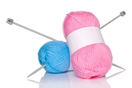 Balls of wool and knitting needles isolated on a white background.の写真素材
