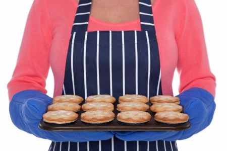 Woman holding a tray of freshly baled mince pies.の写真素材