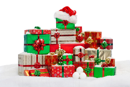 A stack of gift wrapped Christmas presents on snow, isolated against a white background.の写真素材