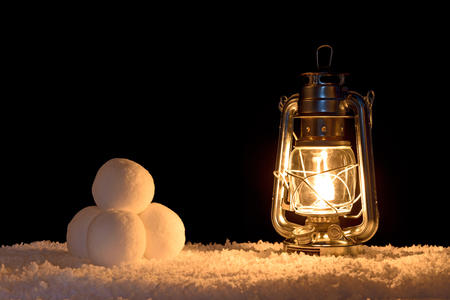 Snowballs illuminated by the light of an oil filled lampの写真素材