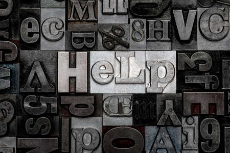The word Help made from old metal letterpress lettersの写真素材