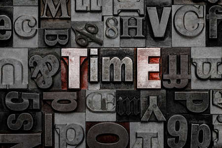 The word Time made from old metal letterpress letters.