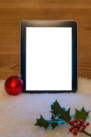A Christmas still life with blank tablet screen and clipping path to add your own message.の写真素材