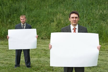 businessmen holding sheet of paperの写真素材