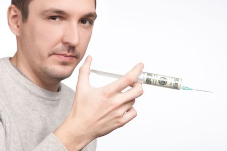 man holding syringe filled with currencyの写真素材