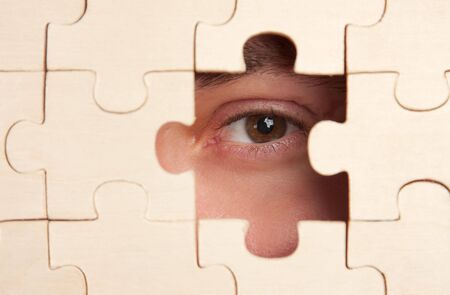 eye watching through puzzlesの写真素材