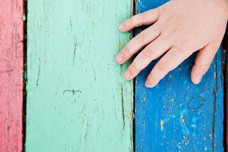 color wooden boards with child handの写真素材