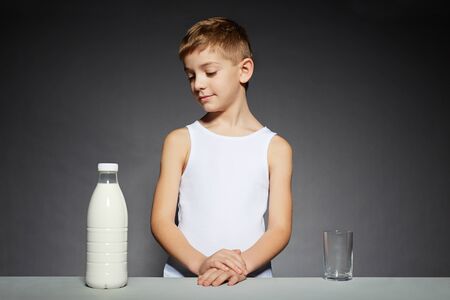 Boy standing looking at milkの写真素材