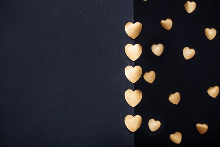 Gold heart stickers over dark textured backgroundの写真素材