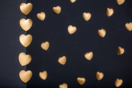 Gold hearts stickers on dark  background