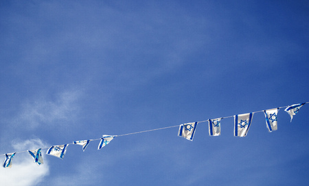 Israeli flags, blue and white hanging as a chain, street decoration for the Israel Independence Day (Yom Haatzmaut),  Israeli Star of David official flagsの写真素材