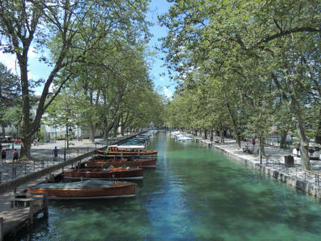Boats moored at the Annecy lake channelの写真素材