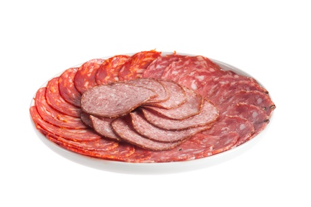 Chorizo, salchichon and salami pork sausages on a plate isolated over white backgroundの写真素材