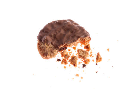Chocolate cookie with crumbs isolated on whiteの写真素材