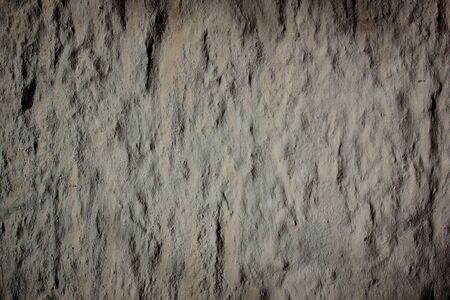 Dark grey plaster concrete wall wallpaper backgroundの写真素材