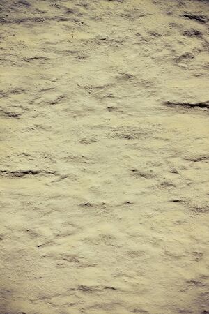 Light yellow brushed cement wall background textureの写真素材