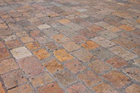 Vintage old stone paved avenue street road in old town in Europeの写真素材