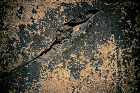 Deep cracked painted plaster concrete wall background. Dark edgedの写真素材