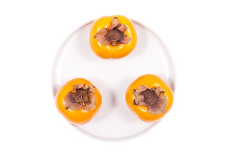 Fresh persimmon fruits on a white backgroundの写真素材