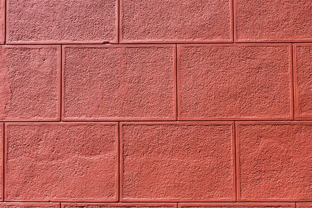Vintage red painted plaster concrete wall backgroundの写真素材