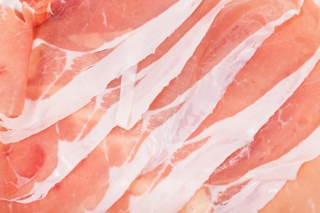 Slices of italian ham prosciutto crudo close-upの写真素材
