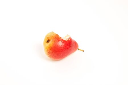 Tasty pear with a bite missing, white backgroundの写真素材