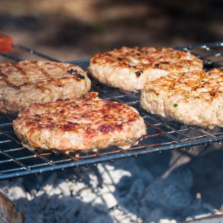Four Hamburgers on Barbeque Grillの写真素材