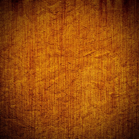 old, grunge background plaster texture in orange. Dark edgedの写真素材