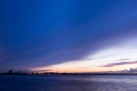 silhouette of Tallinn Estonia with fire sea sunsetの写真素材