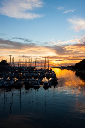 harbour and the yachts at dramatic sunsetの写真素材