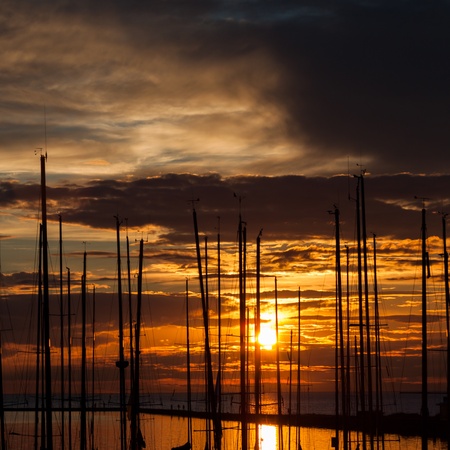 harbour and the yachts at dramatic sunsetの写真素材