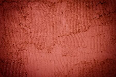 Background made with a texture of a red wallの写真素材