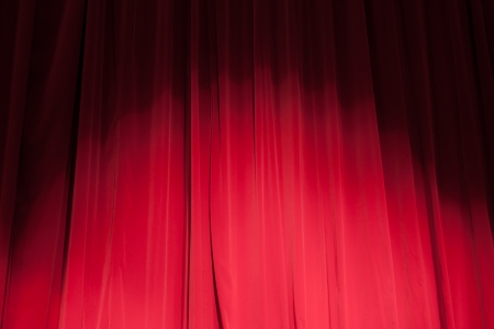 Curtain from the theatre with a spotlight as backgroundの写真素材