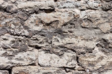 Old stone wall as a background textureの写真素材