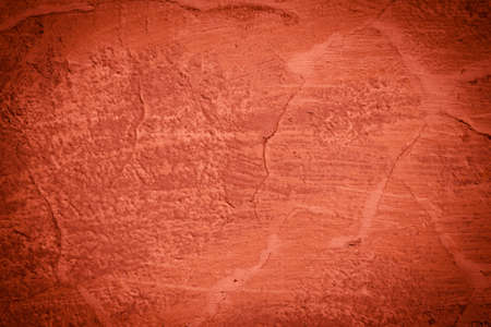 Red background wall texture - cracked and dark edgesの写真素材