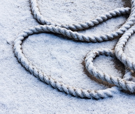 frozen ship cable under snowの写真素材